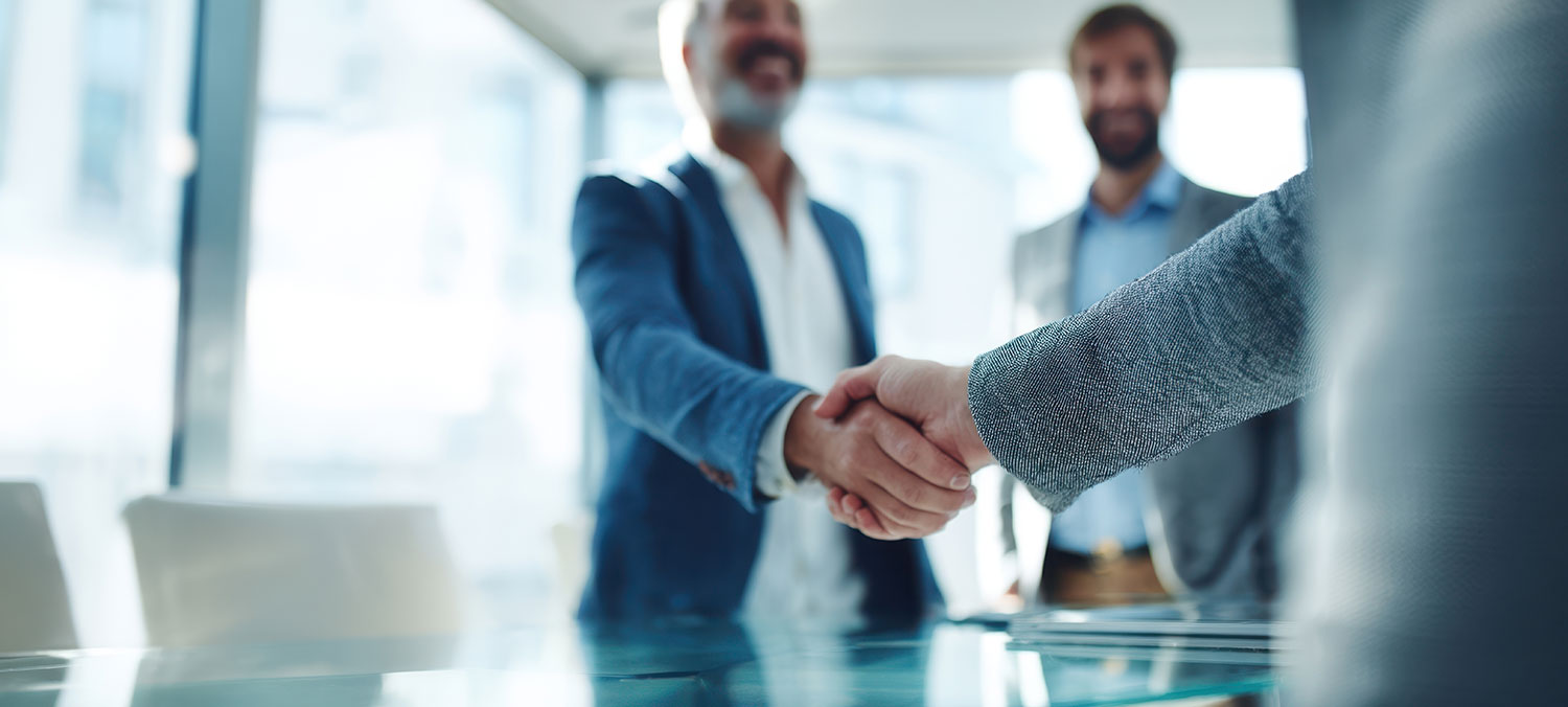An image of business men shaking hands.